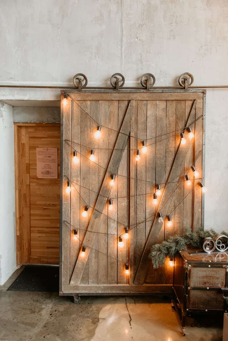 yellow string lights on brown wooden door