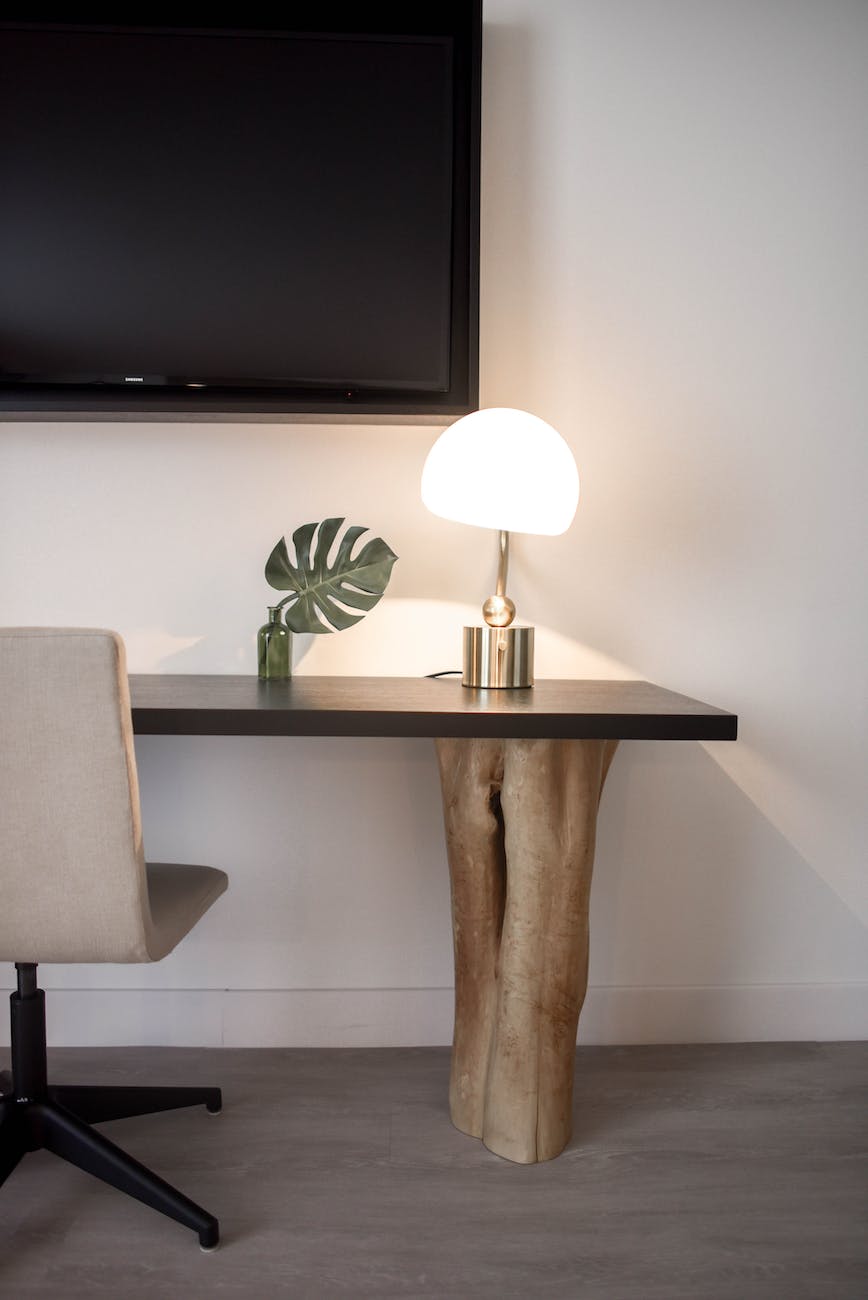stainless steel base white shade table lamp on brown wooden desk near white painted wall with wall mounted flat screen t v small table lamps