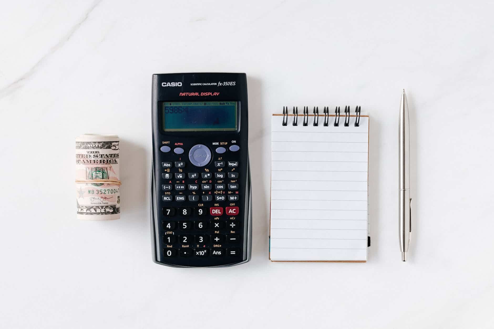 composition of calculator with paper money and notebook with pen space planning in interior design