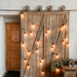 yellow string lights on brown wooden door